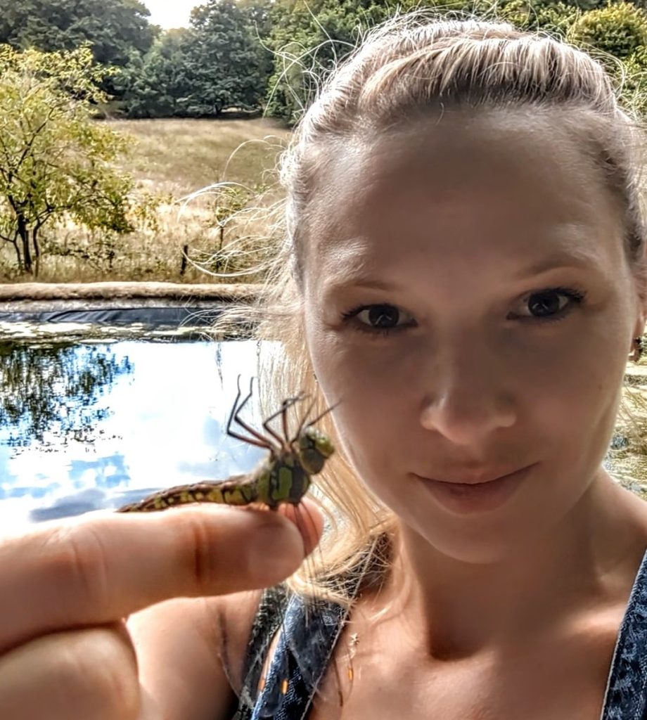 Photo of a woman holding a dragonfly