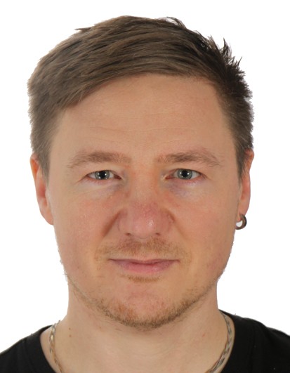 Photo of a man with short hair and an earring