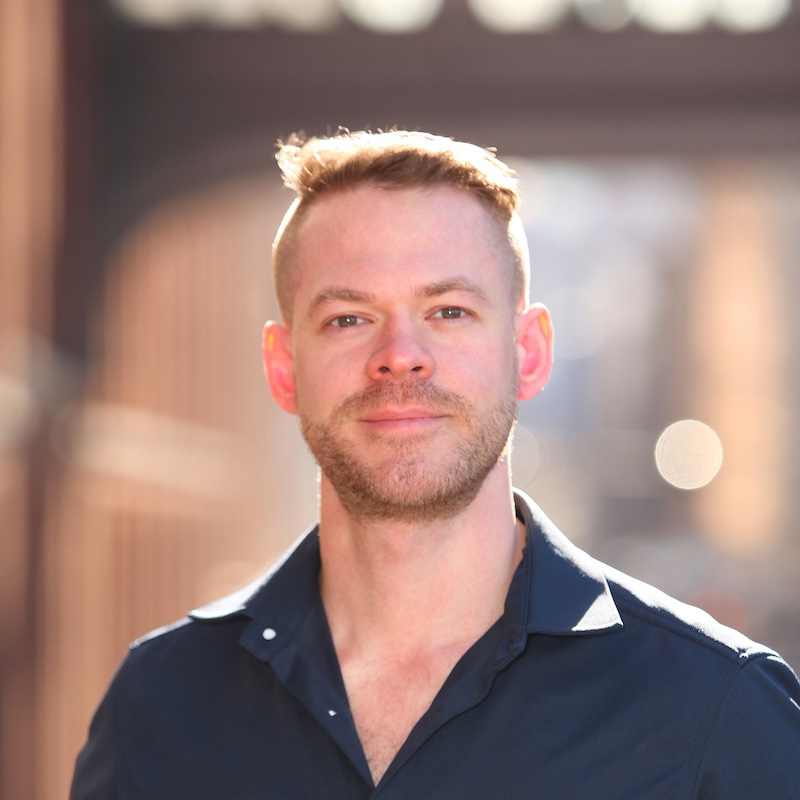 Photo of a man wearing a blue shirt.
