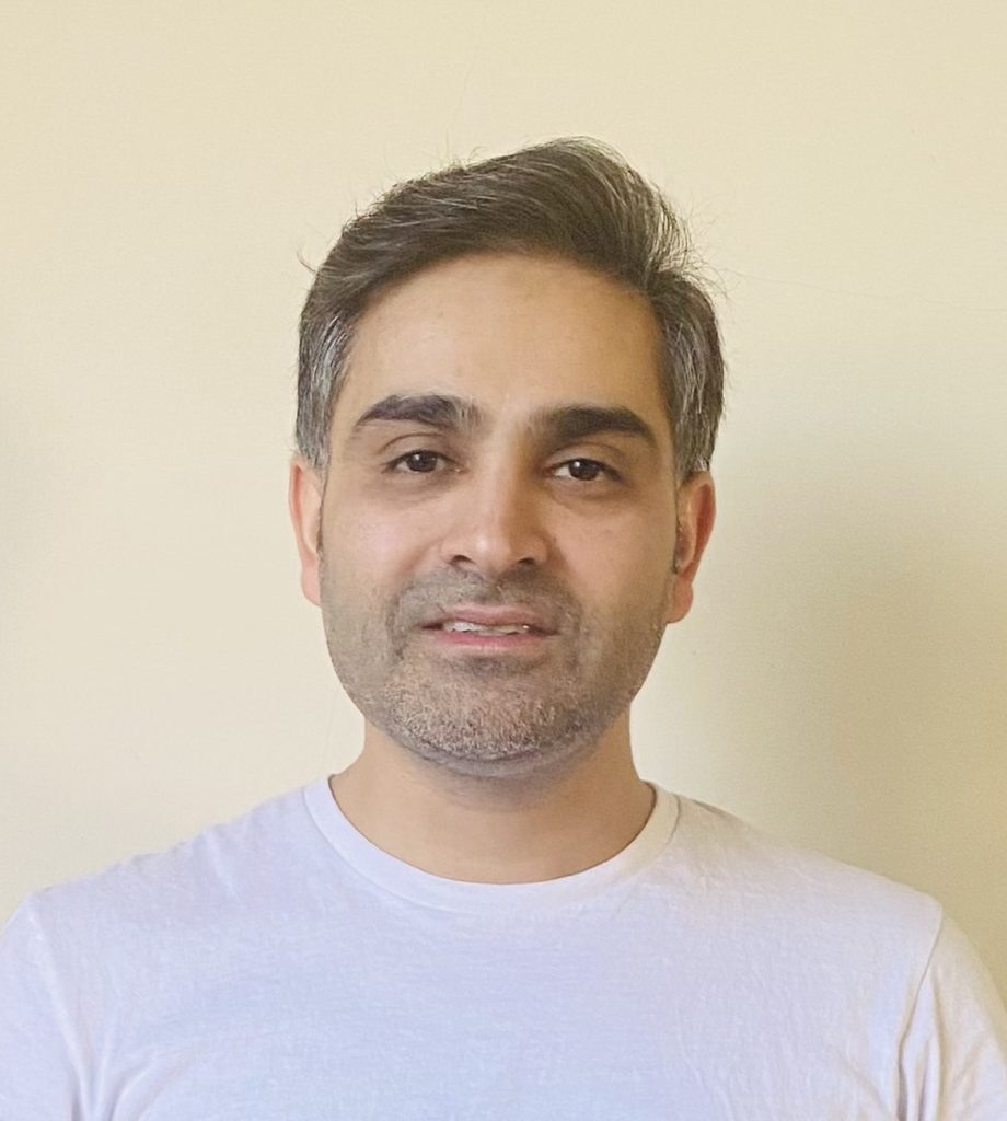 Photo of a man wearing a white shirt.